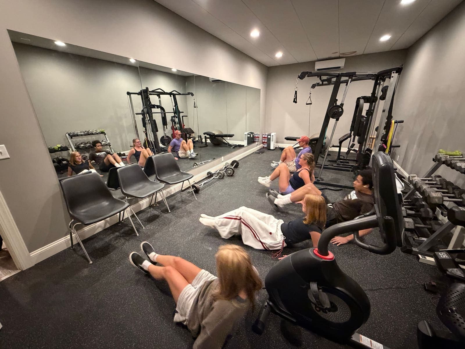 StreetRobin team members working out together in the on-site gym.