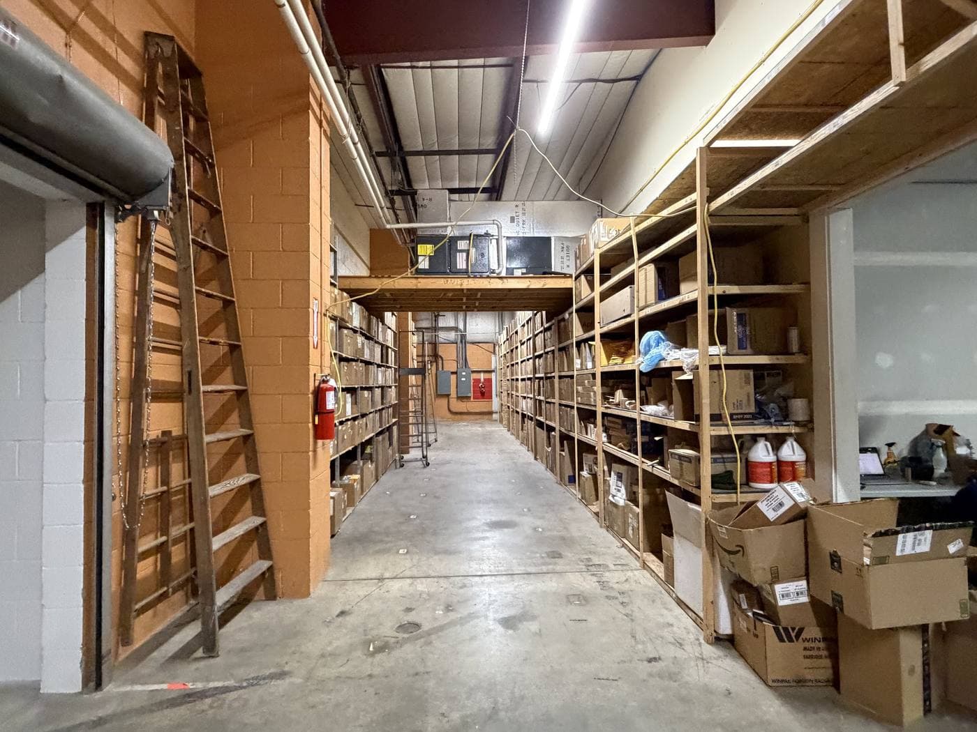 A quiet aisle of restored inventory shelved and ready to go back into use.