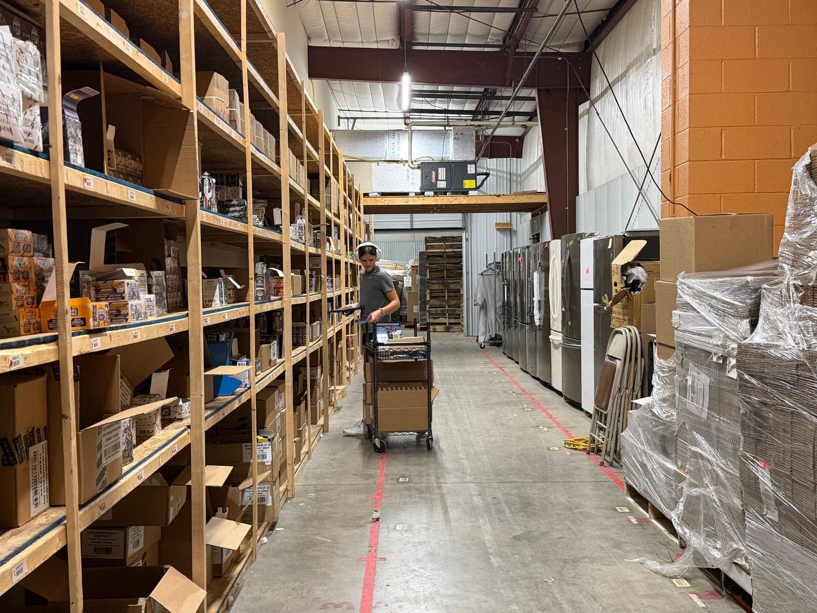 Aisles of organized, labeled shelving inside the StreetRobin warehouse.